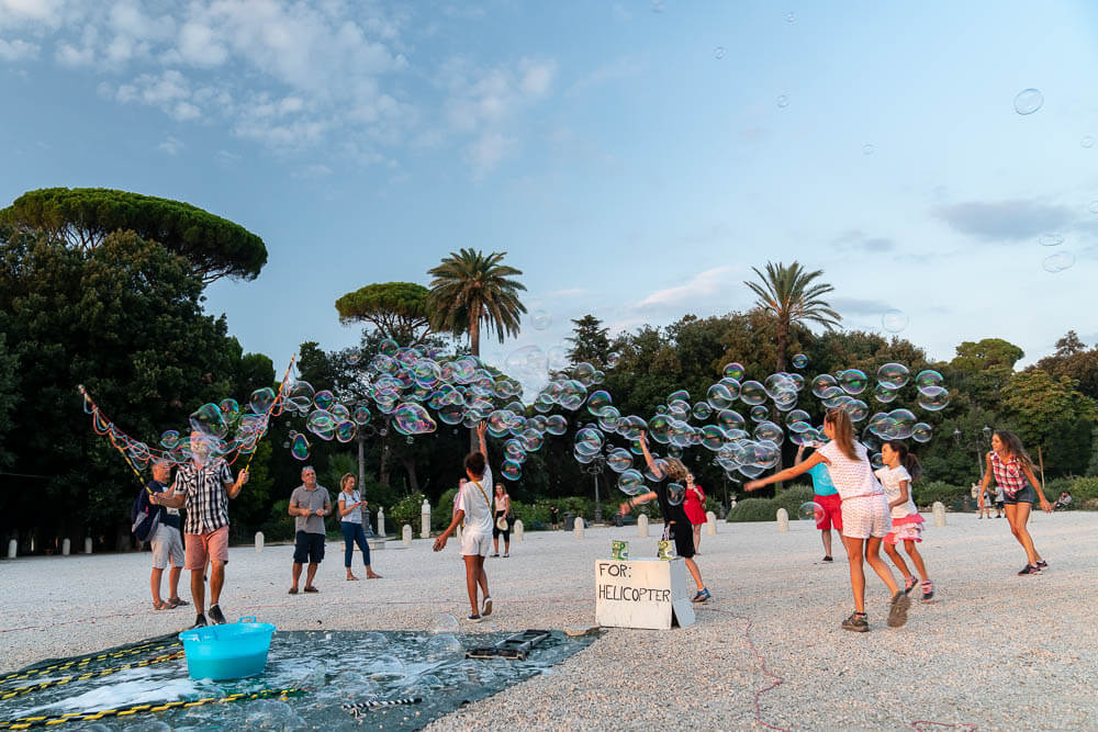 Kids enjoying a large bubble cloud